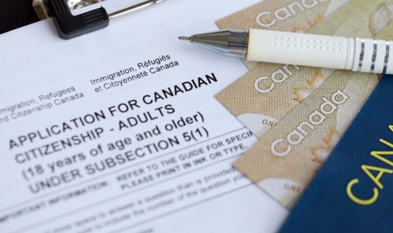 Application for Canadian citizenship for adults on table with pen, passport and dollar bills
