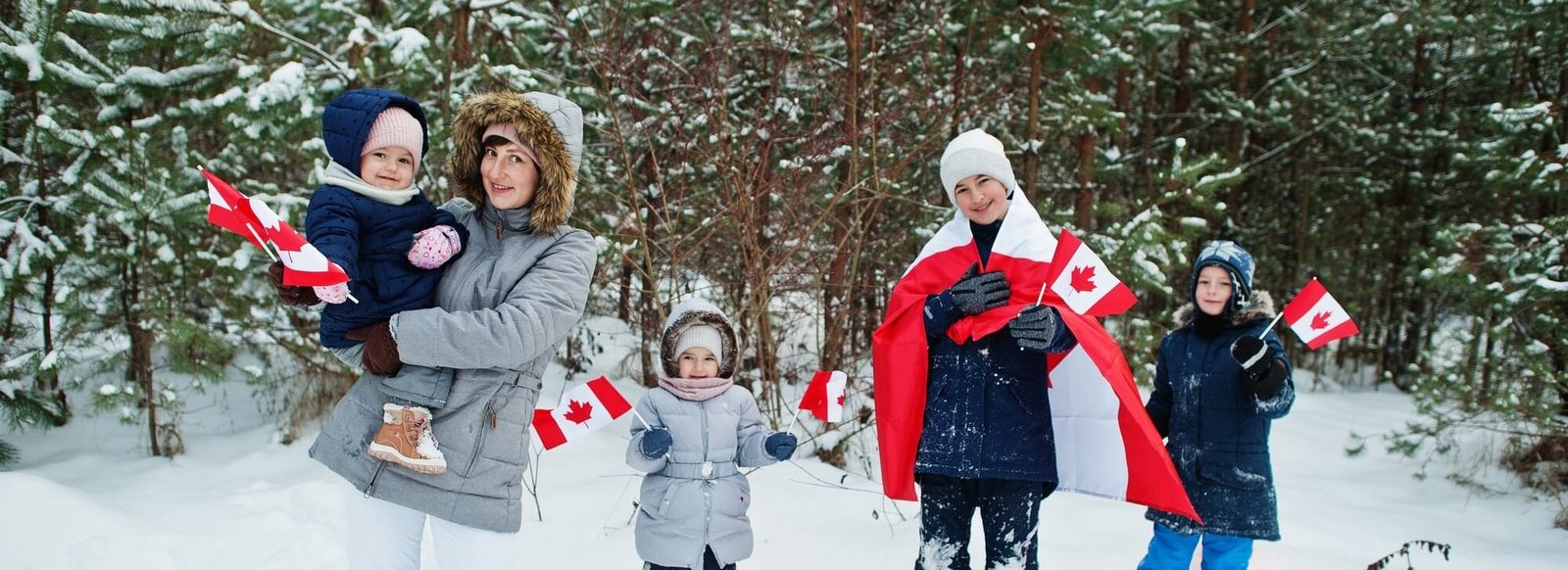 Mother with kids holding flag of Canada on winter landscape. Mother with kids holding flag of Canada on winter landscape.