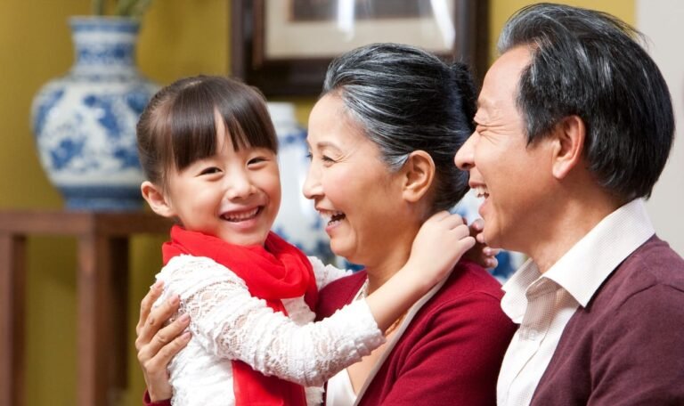 Grandparents embracing granddaughter during Chinese New Year